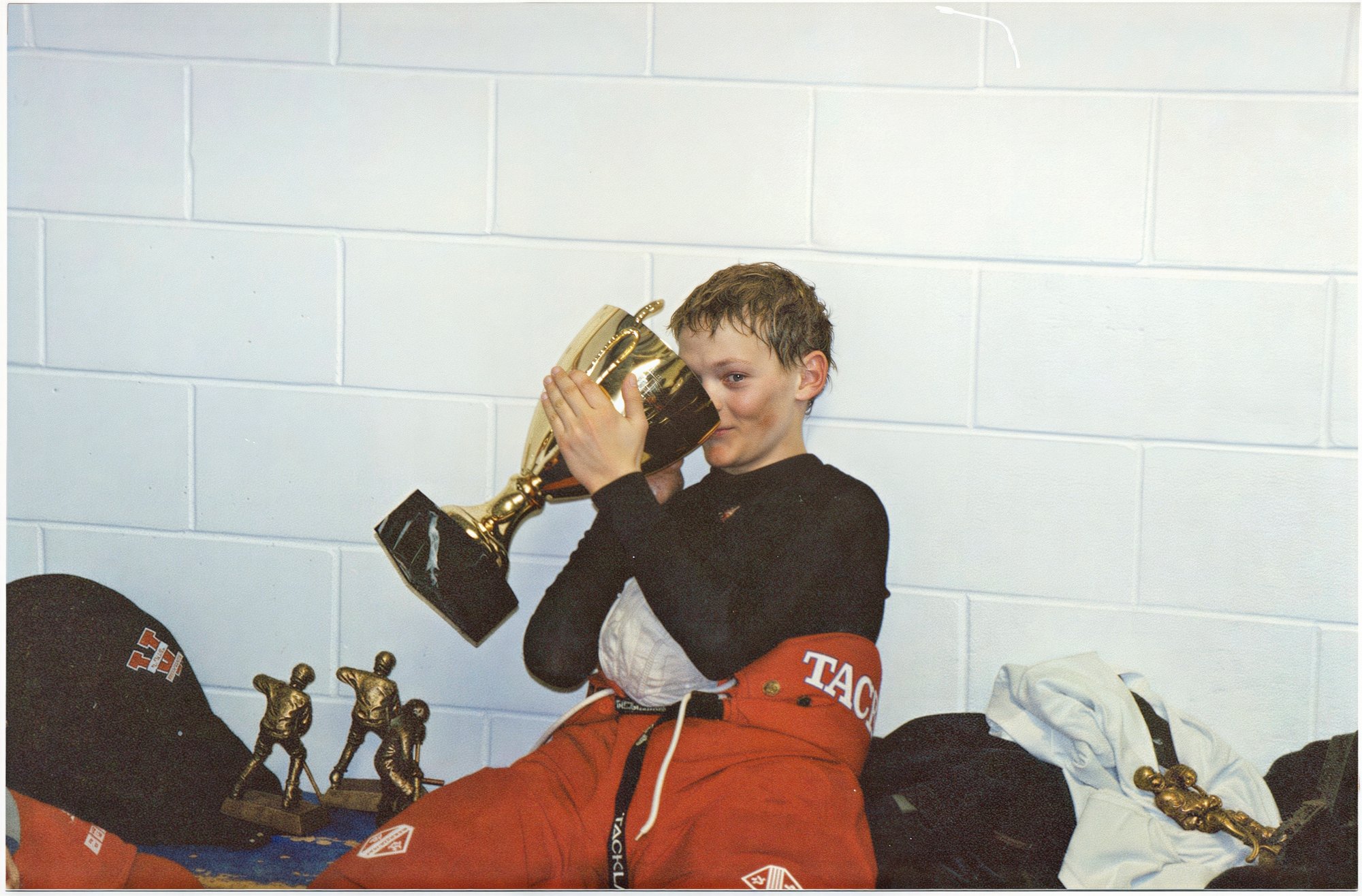 Alex Biegler drinking a soft drink from the championship cup.  Notice the giant tape ball he accumulated all season!