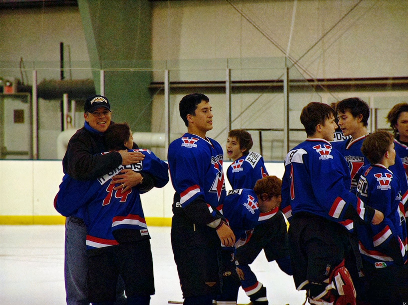 Coach Scott Hovey hugging a player.  This was 2004 and you were still allowed a hug after a championship!